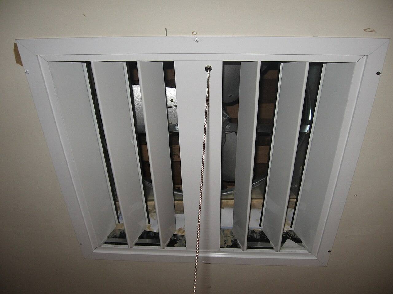 Photo of a whole-house fan, turned on, with the camera flash freezing the blades in stop-motion.