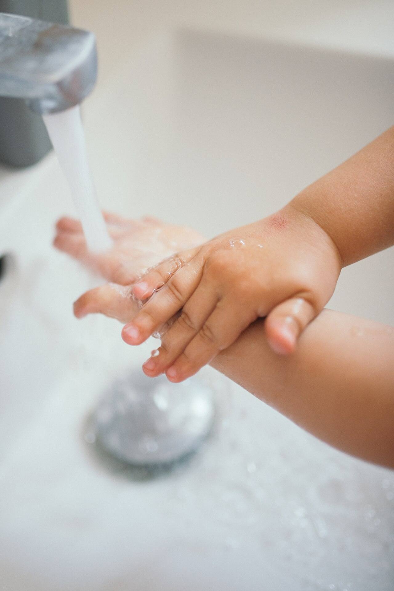 Child washing hands closeup