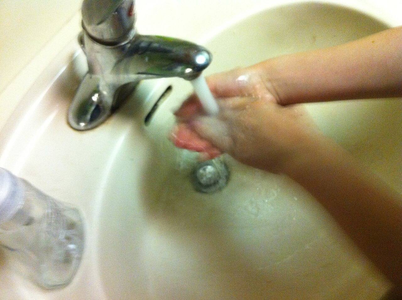 A picture of a child washing hands.